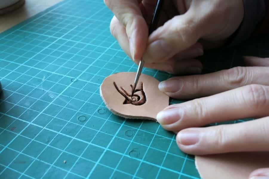 Hand painting a motif onto leather
